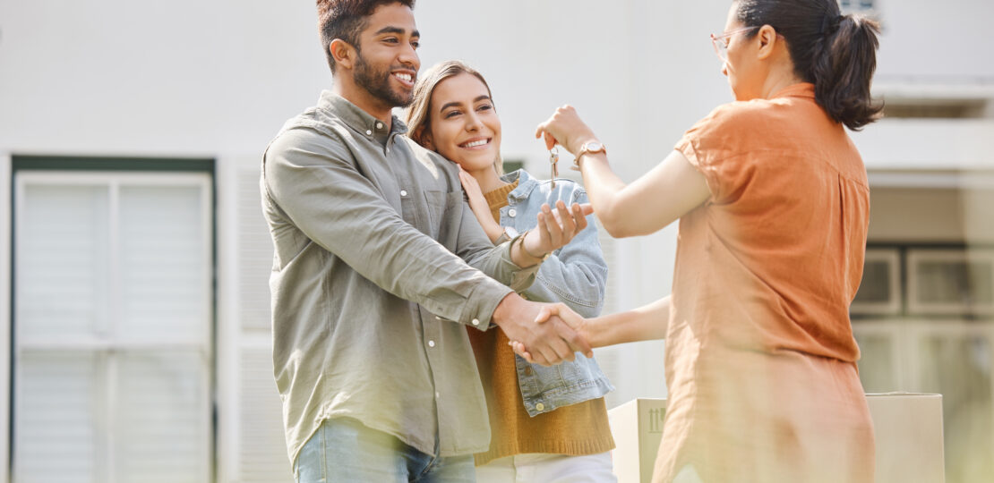 house-key-realtor-woman-and-handshake-with-couple-2026-01-09-10-03-09-utc